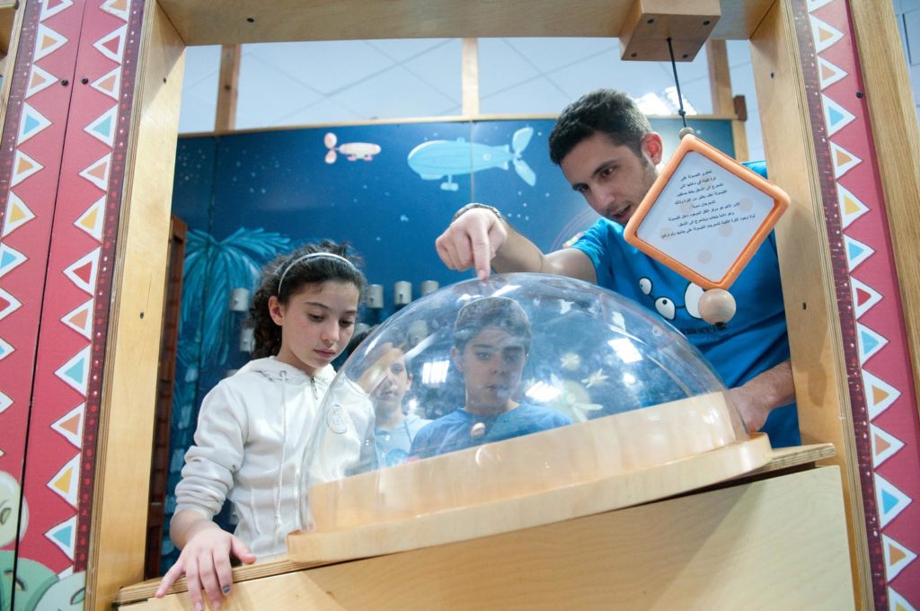 BGU students participating in the Perach Tutor Program take their young students on a trip to a local science center.
