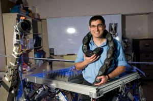 Dr. Amir Shapiro with his "robot snake" that can slither through pipes and narrow openings.