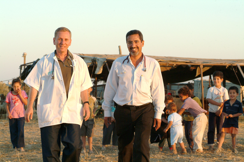 Prof. Ohad Birk, left, with colleague Dr. Khalil Elbedour in a Bedouin village.