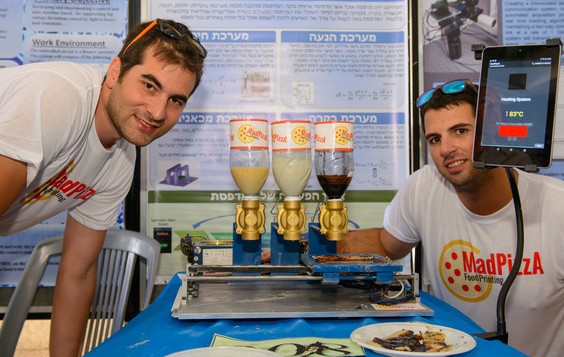 The recent BGU graduates with a prototype of their 3-D food printer
