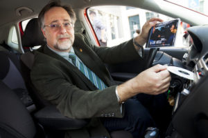 Dr. Warren Brodsky inserting a CD in his car stereo (Photo: Elisha Brodsky)